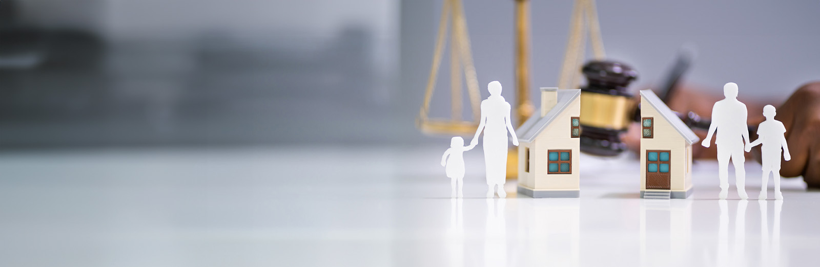 A model home with a paper family that's being split apart, representing divorce in Illinois