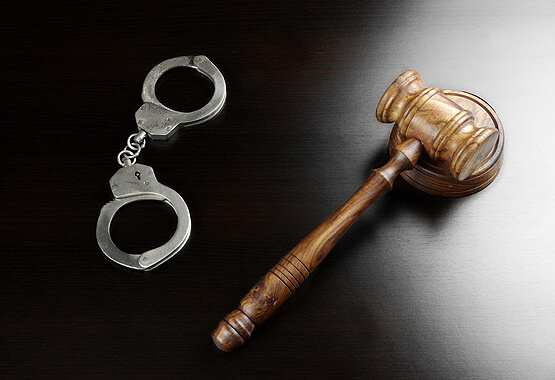 gavel and handcuffs on a table