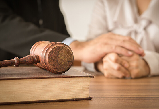 gavel on a book with a man and woman in the background