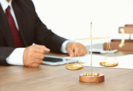 man with justice scales on his desk