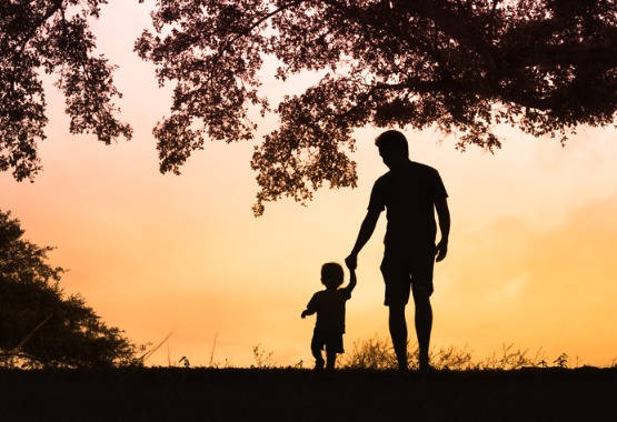 A father holding hands with their child after receiving help with Family Law in Peoria IL