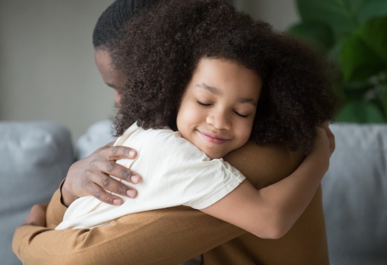 A daughter hugging her father