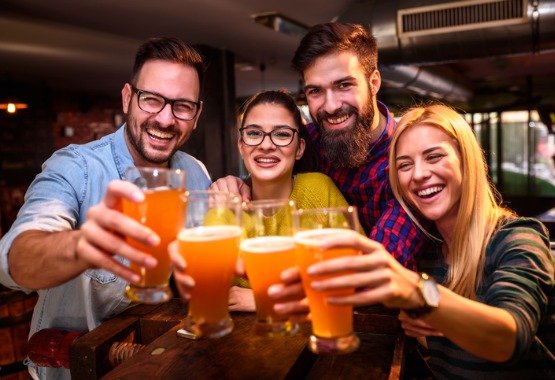 group of adults drinking beer at the bar