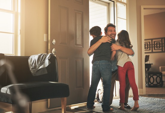 A happy dad hugging his children during Visitation in East Peoria IL