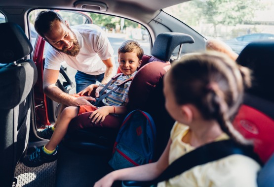A dad putting kids in his car, being their guardian per Custody Law in East Peoria IL