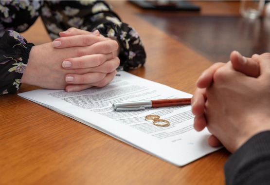 A couple sitting down with a Divorce Attorney in Pekin IL and looking over paperwork